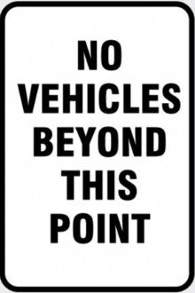 NO VEHICLES BEYOND THIS POINT SIGN